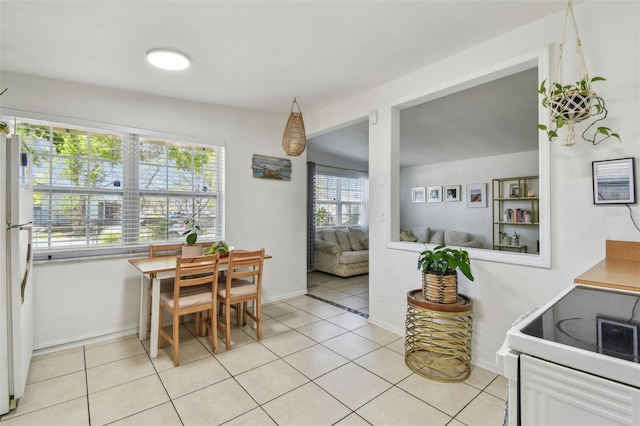 dining room featuring light tile patterned floors and baseboards