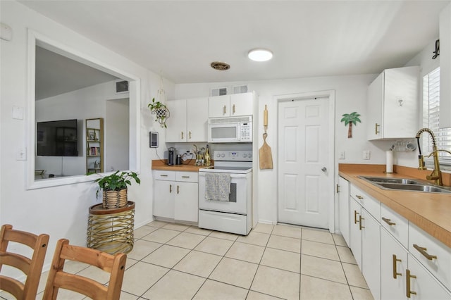 kitchen featuring a sink, white appliances, white cabinetry, and light countertops