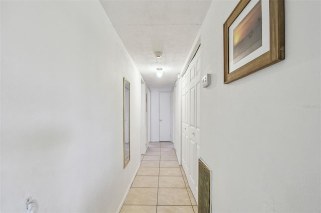 corridor with light tile patterned floors and visible vents