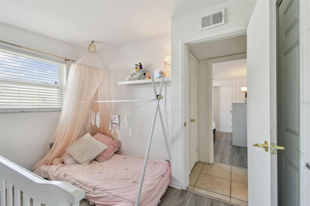 tiled bedroom featuring visible vents