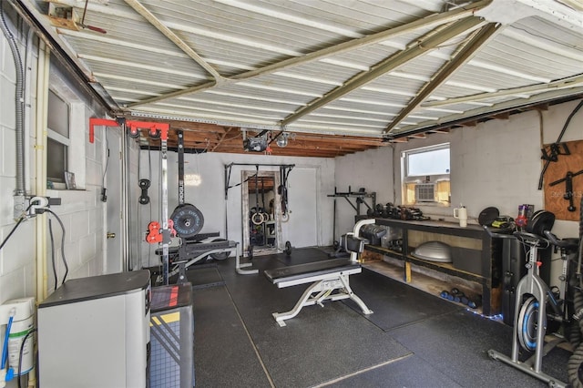 workout area with a garage, a workshop area, and concrete block wall