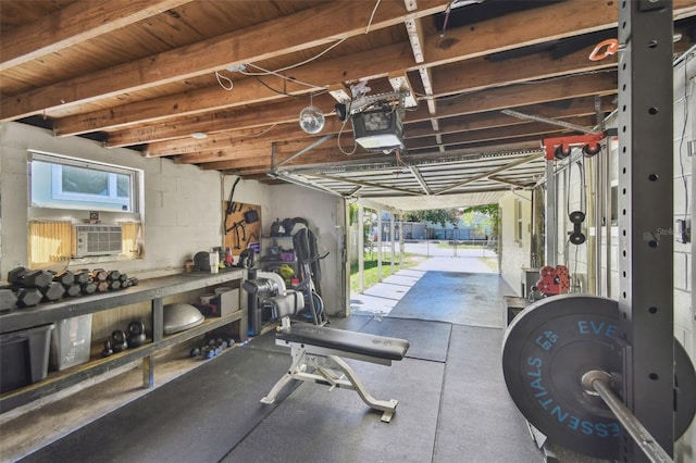 garage featuring concrete block wall, cooling unit, and a garage door opener