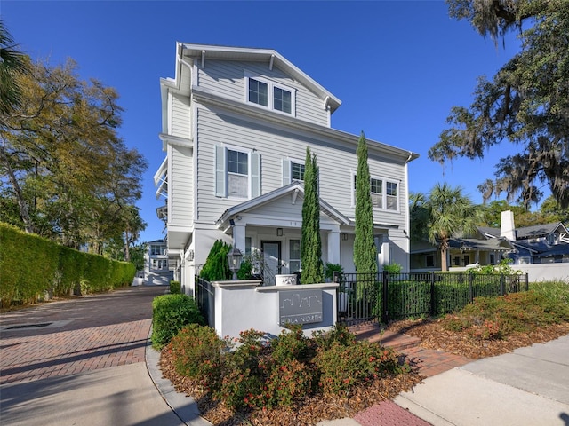 view of front of home featuring a fenced front yard and driveway