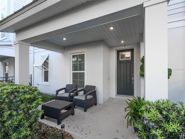 doorway to property featuring stucco siding and a patio area