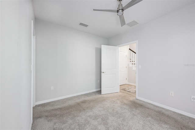 spare room featuring visible vents, ceiling fan, baseboards, and carpet