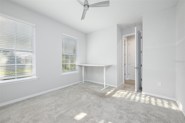 unfurnished bedroom with carpet flooring, a ceiling fan, and baseboards