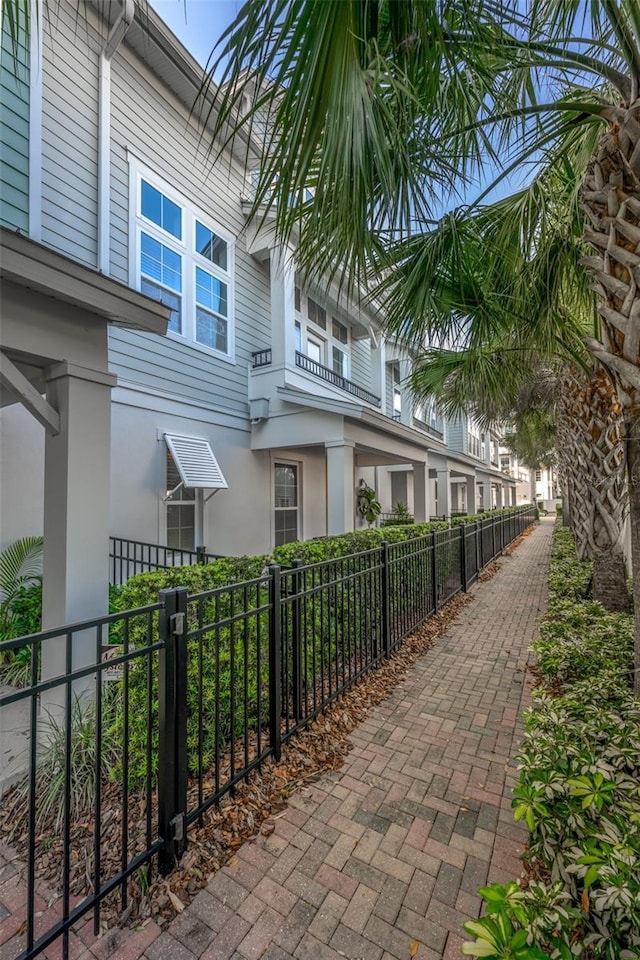 view of property exterior with a fenced front yard and stucco siding