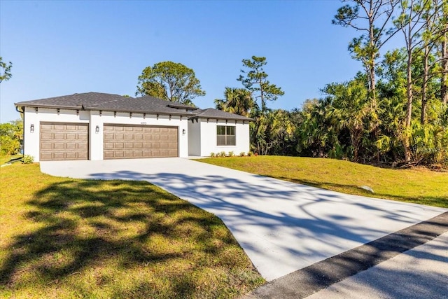 view of front facade featuring a front lawn, an attached garage, driveway, and stucco siding