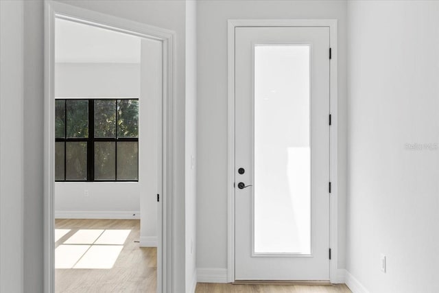 interior space with light wood-type flooring and baseboards