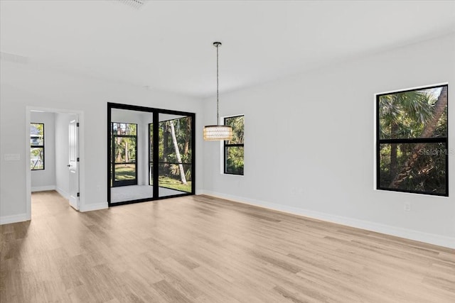 spare room with light wood finished floors and baseboards