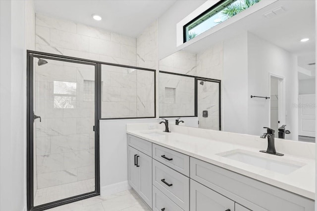 full bath with double vanity, a stall shower, marble finish floor, and a sink