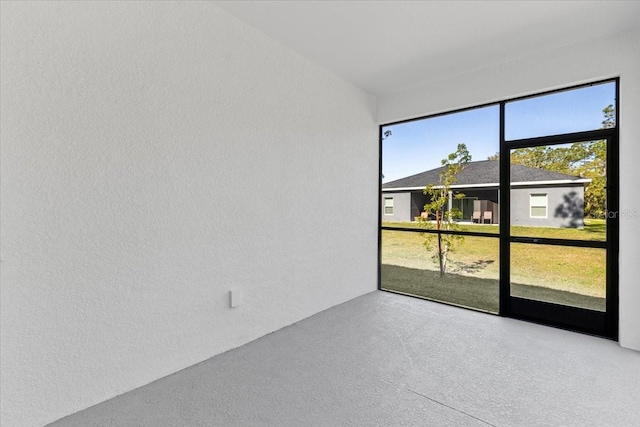 spare room with concrete flooring