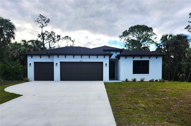 4313 Appleton Ter, North Port, FL 34286 - view of front of home featuring stucco siding, concrete driveway, a garage, and a front lawn