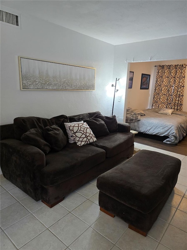 tiled living room featuring visible vents