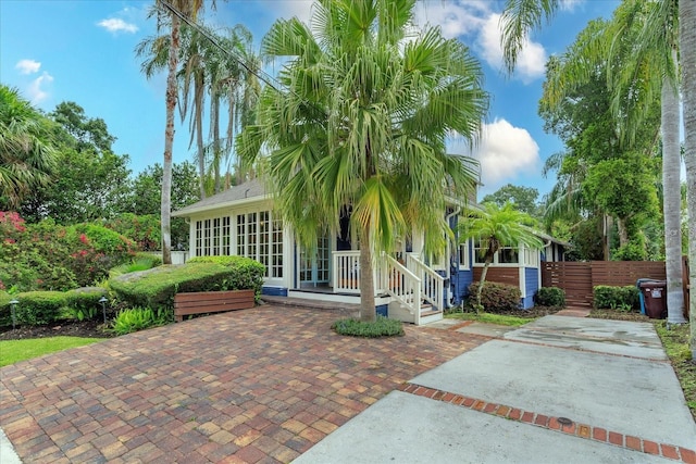 exterior space with a sunroom and fence