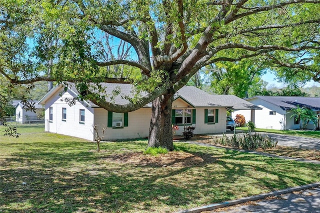 ranch-style home with driveway and a front yard