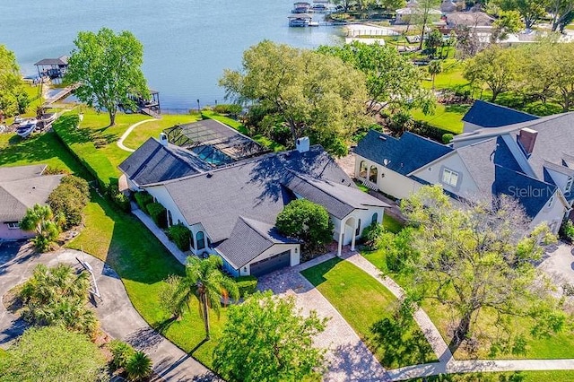 drone / aerial view featuring a residential view and a water view