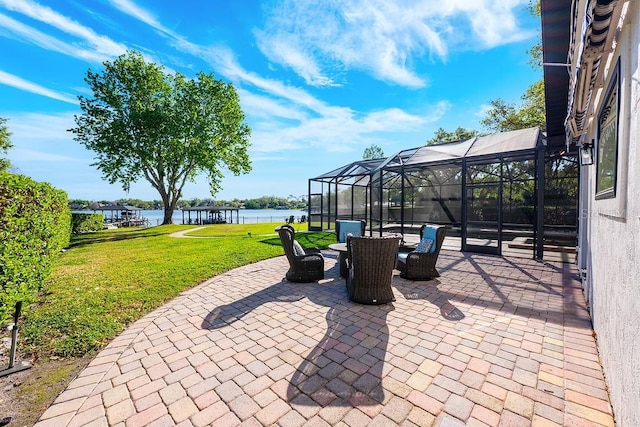 view of patio with glass enclosure and a water view