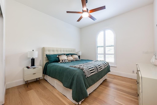 bedroom with baseboards, light wood finished floors, and ceiling fan