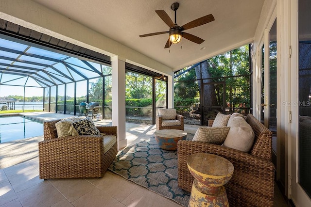 sunroom featuring a healthy amount of sunlight, lofted ceiling, and ceiling fan