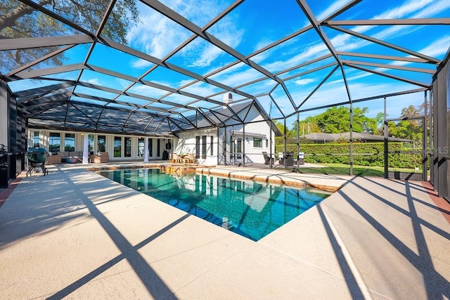 outdoor pool with a lanai and a patio area