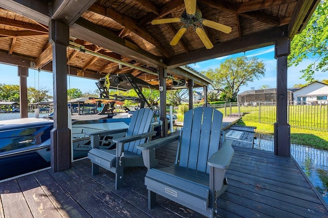 wooden deck featuring ceiling fan and fence