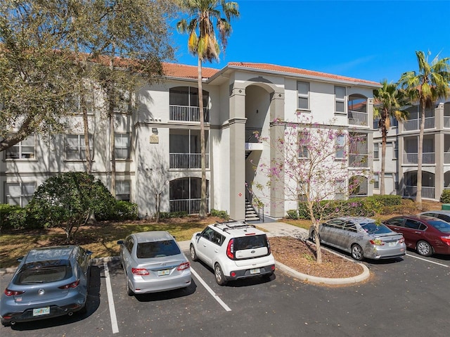 view of building exterior featuring uncovered parking