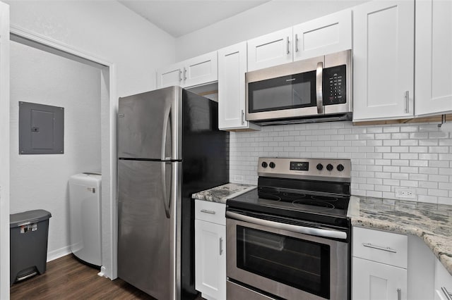 kitchen with backsplash, white cabinets, stainless steel appliances, and electric panel
