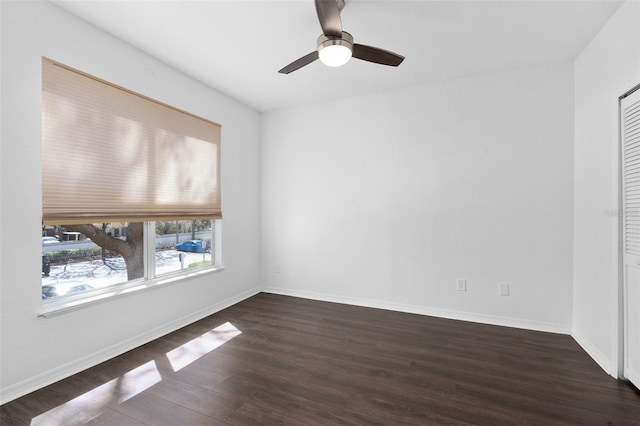 unfurnished room with baseboards, ceiling fan, and wood finished floors