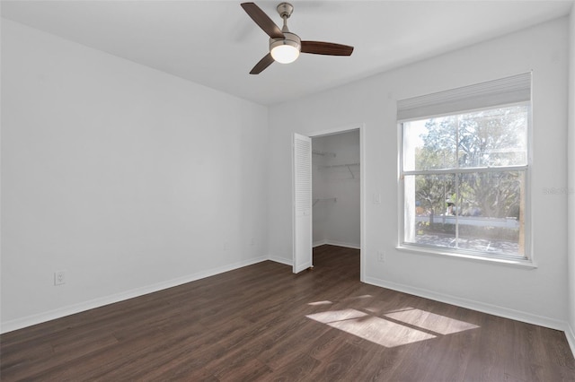 unfurnished bedroom featuring baseboards and dark wood-style floors