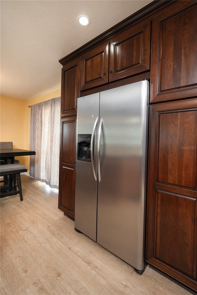 kitchen with dark brown cabinetry, recessed lighting, stainless steel refrigerator with ice dispenser, and light wood finished floors