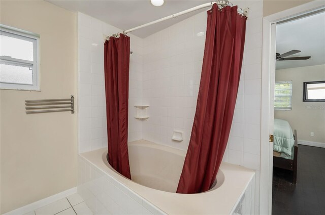 full bath with shower / bathtub combination with curtain, baseboards, ensuite bath, and tile patterned flooring