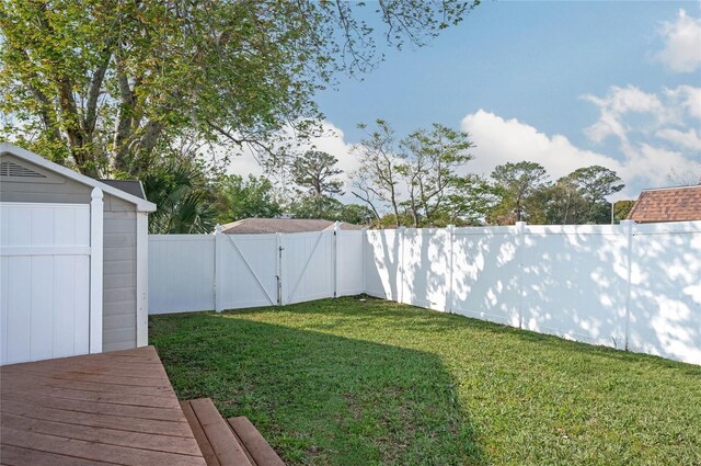 view of yard featuring a fenced backyard and a gate