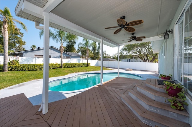 view of pool featuring a lawn, a fenced backyard, a fenced in pool, ceiling fan, and a patio area