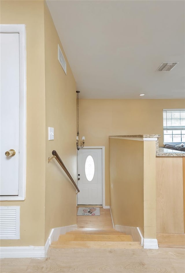 entrance foyer with baseboards and visible vents