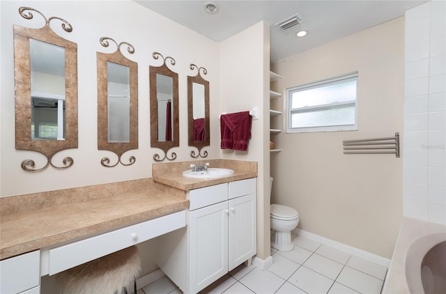 bathroom with vanity, a tub to relax in, visible vents, tile patterned floors, and toilet