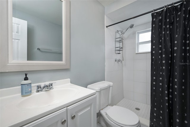 full bathroom featuring toilet, vanity, and a tile shower