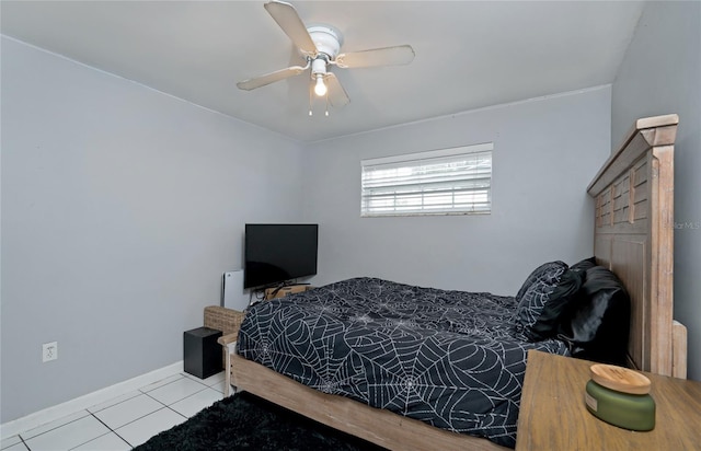 bedroom with tile patterned floors, baseboards, and ceiling fan