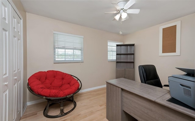 office space with light wood finished floors, baseboards, and ceiling fan