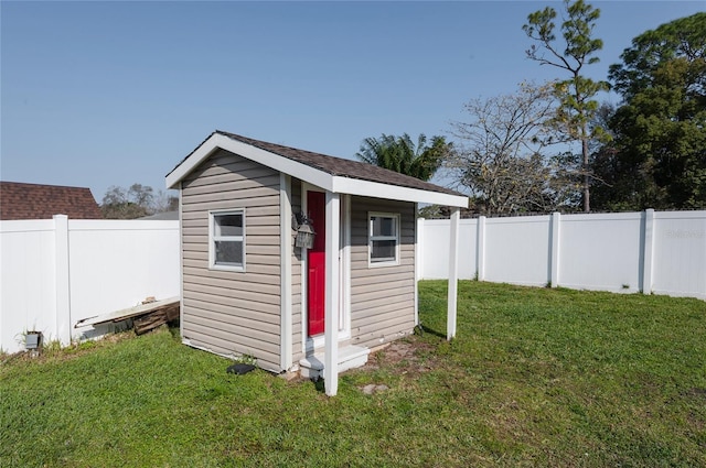 view of shed with a fenced backyard