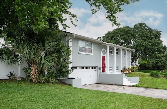 504 Teakwood Dr, Altamonte Springs, FL 32714 - view of front of home featuring a garage, driveway, stucco siding, and a front yard
