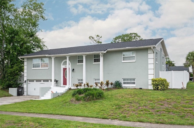 504 Teakwood Dr, Altamonte Springs, FL 32714 - split foyer home featuring a garage, concrete driveway, and stucco siding