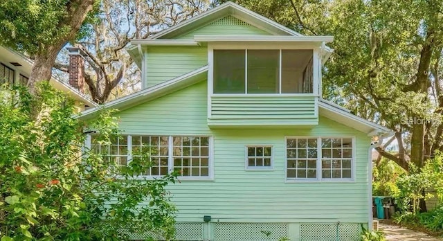 view of side of home featuring a sunroom