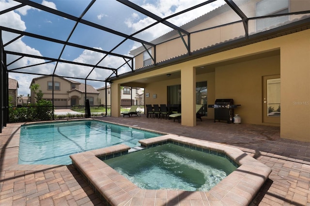 view of pool featuring a patio, a lanai, a pool with connected hot tub, and a grill