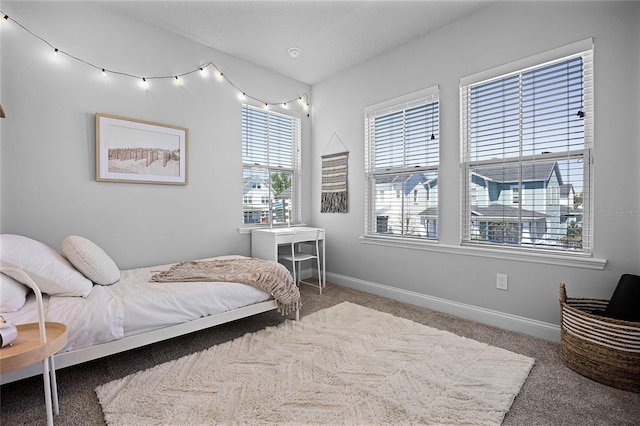 carpeted bedroom featuring baseboards