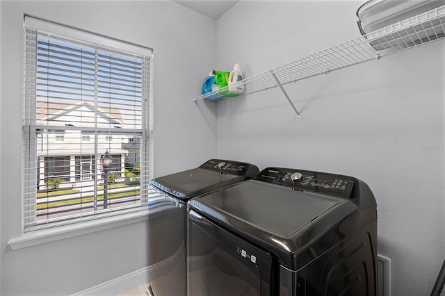 laundry room featuring baseboards, laundry area, and washing machine and clothes dryer