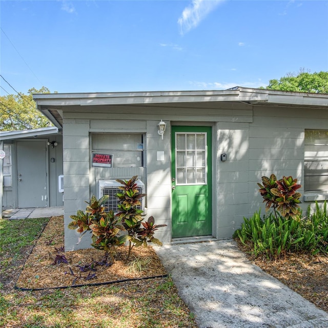 property entrance featuring concrete block siding