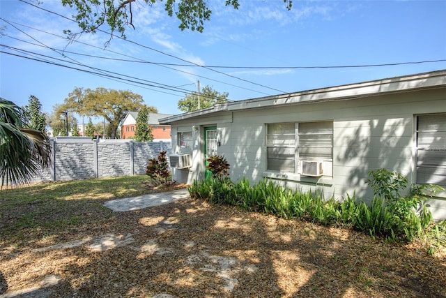 exterior space with cooling unit and fence