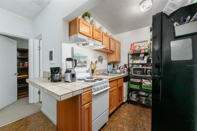 kitchen featuring under cabinet range hood, white appliances, tile countertops, and a sink