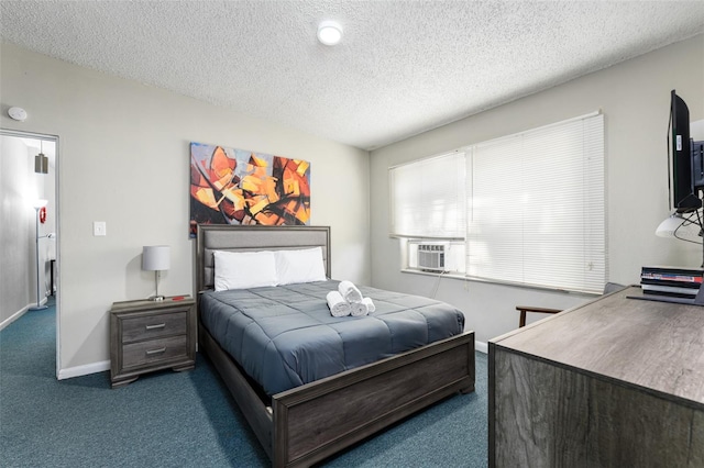 bedroom with cooling unit, baseboards, carpet, and a textured ceiling